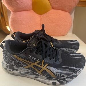 ASICS womans Black and Gold Sneakers